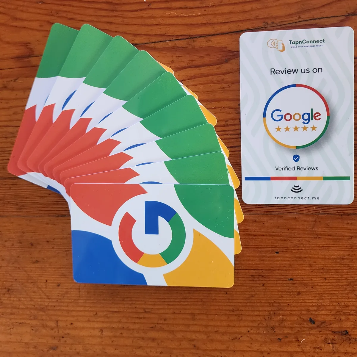 Fanned stack of Google Review NFC cards next to a TapnConnect review card